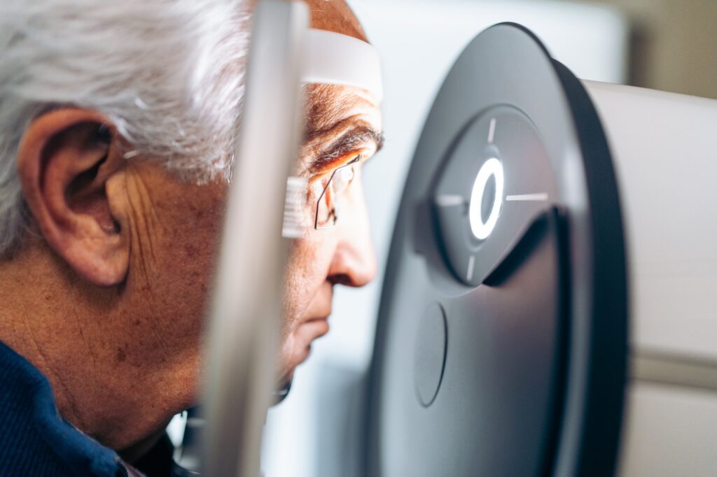 Senior Man Undergoing a Non Invasive Glaucoma Eye Scan in Clinic